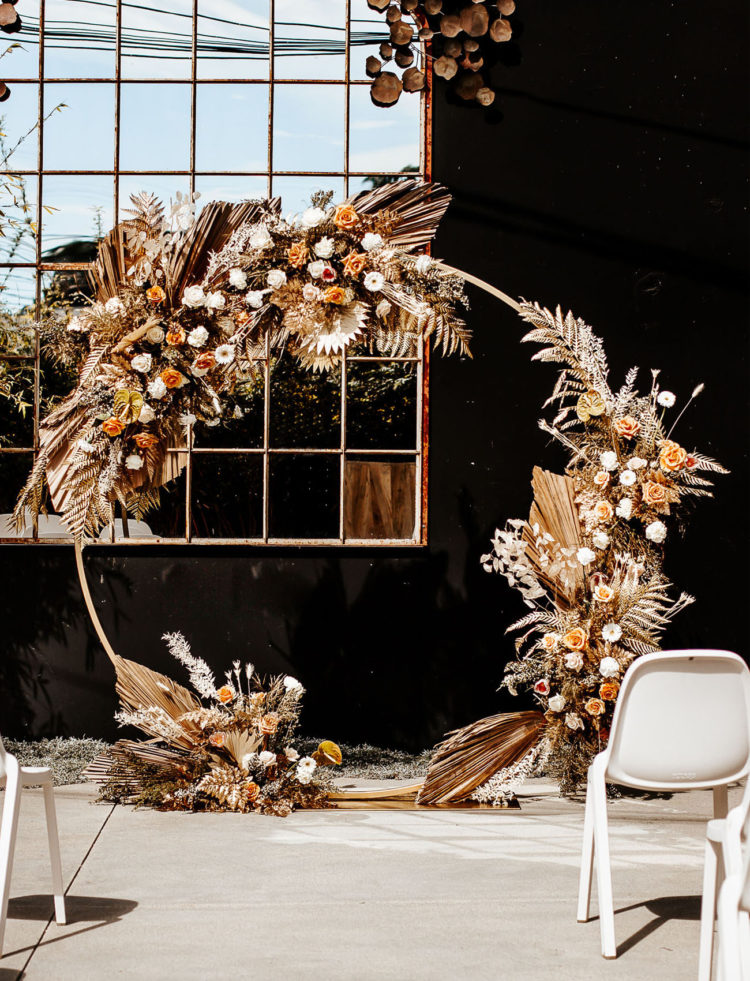 The wedding arch was an incredible one, with peachy blooms, fronds, herbs and leaves