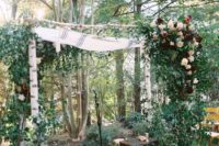 05 a rustic backyard wedding arch of birchwood, greenery, blush and burgundy blooms is great for a rustic and boho fall wedding
