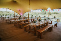 06 The reception was done under a large tent, with colorful buntings and wildflower centerpieces