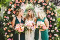 07 The wedding arch was decorated with greenery and bold and blush blooms all over