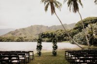 07 The wedding arch was done with tropical leaves and white and blooms and just look at that view