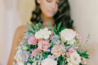 07 The wedding bouquet was done with neutrals, blue and pink blooms and greenery plus long ribbons