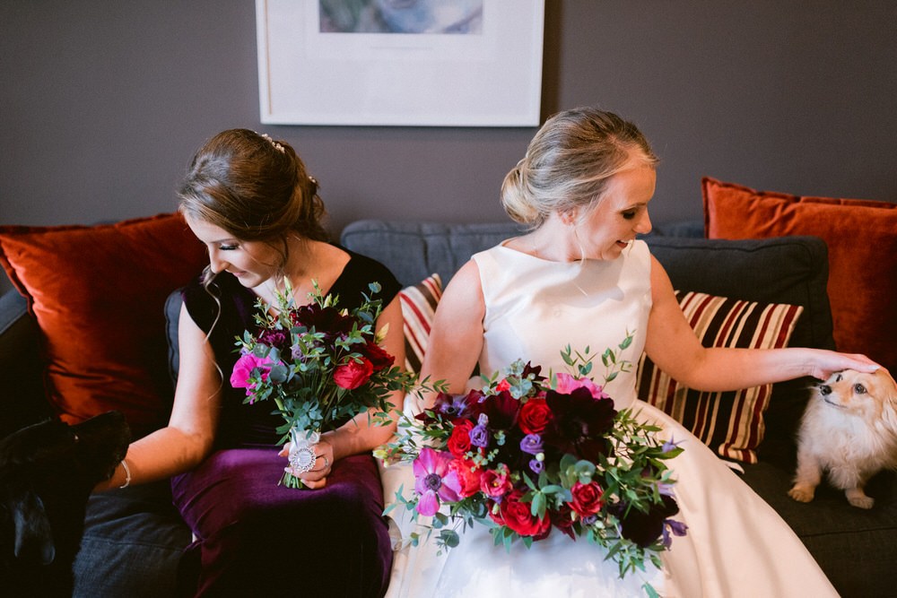 The wedding bouquets were done with red, fuchsia and dark purple blooms and greenery