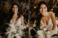 08 The bride finished off her look with statement earrings and was carrying a white wedding bouquet with tropical blooms and large leaves