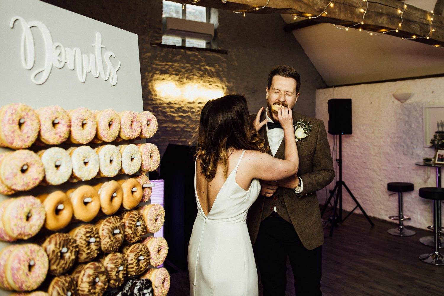 The couple went for a glazed donut wall instead of a traditional wedding cake