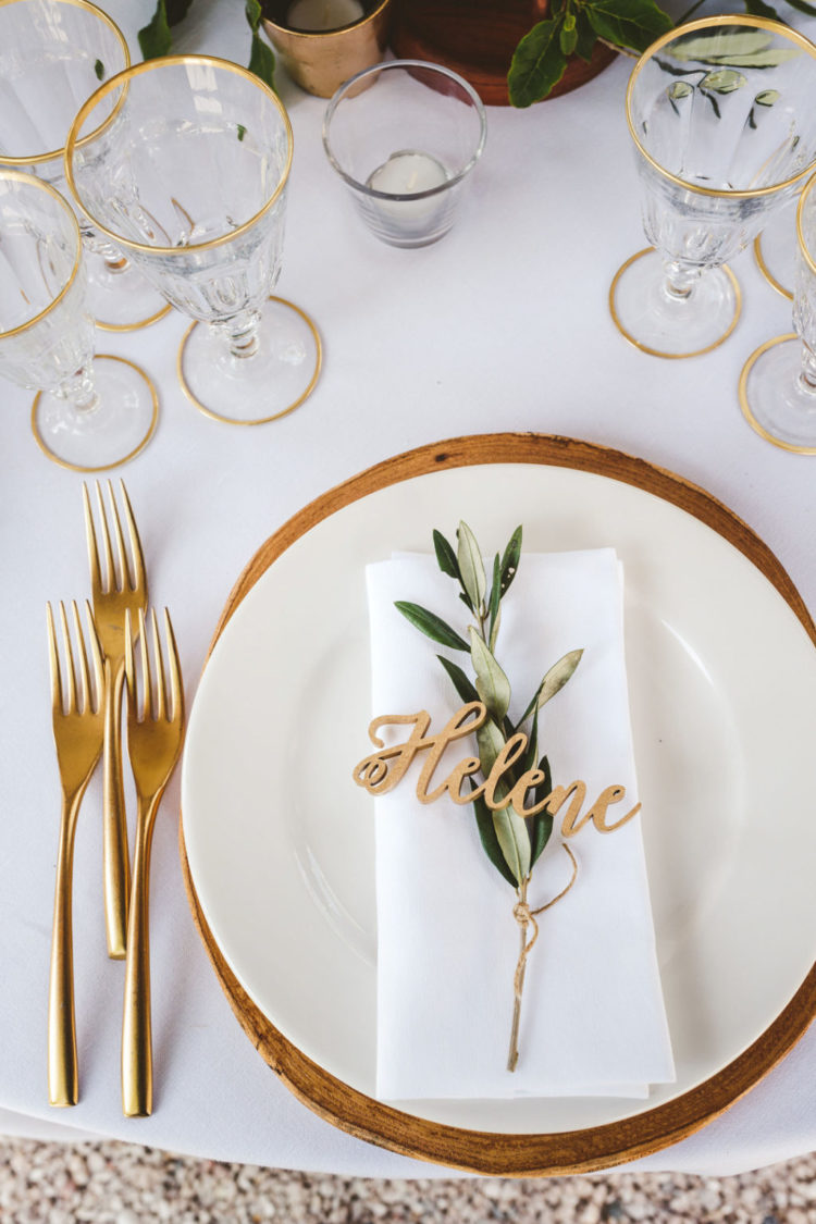 Gold cutlery, gold rim glasses and wooden chargers finished off the look