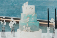 a blue wedding cake with white layers