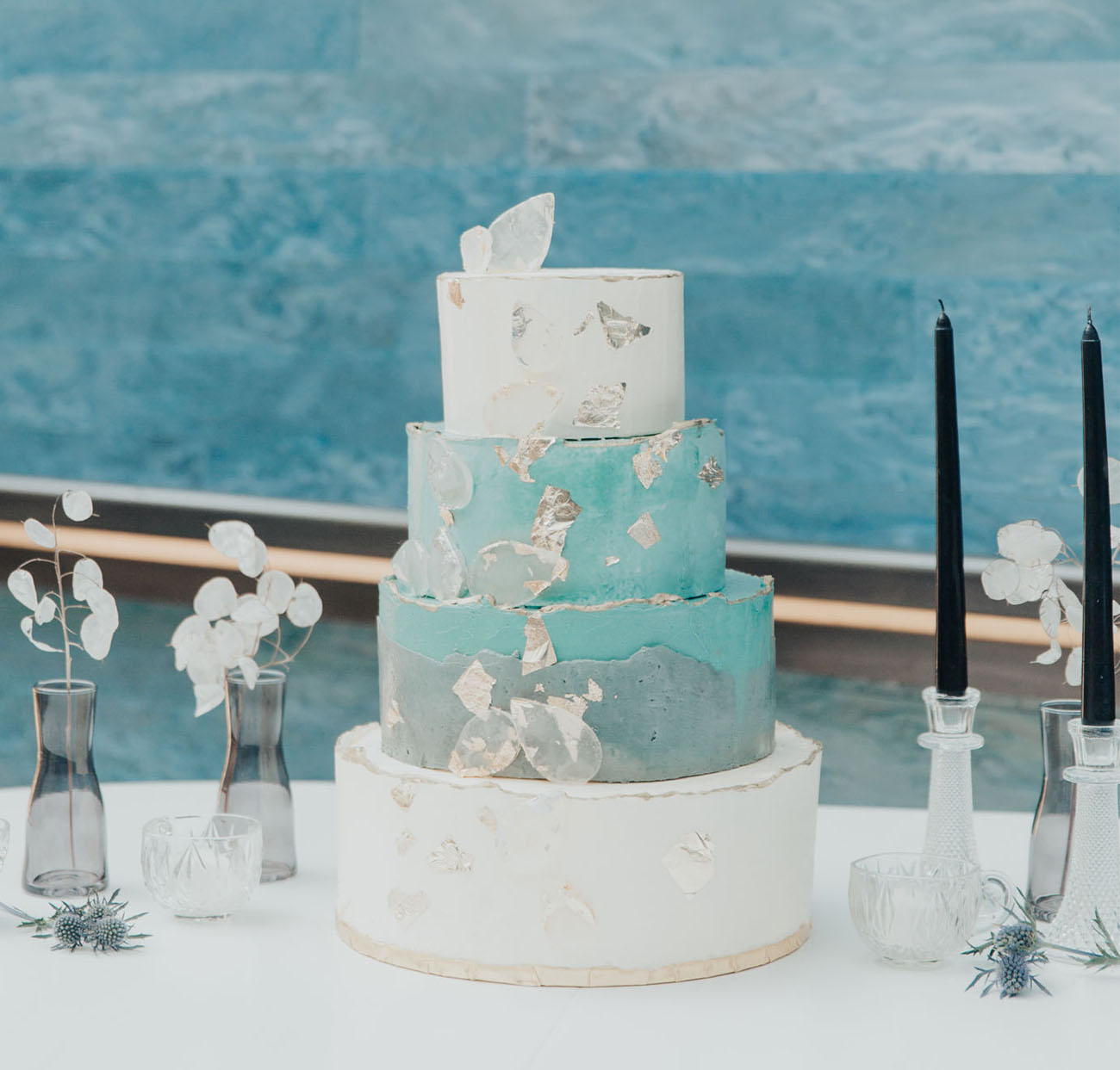 The wedding cake was done with white and blue tiers, with silver edges and edible glass