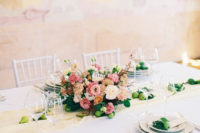 10 The wedding tablescape was done in neutrals, with a pink floral centerpiece, green fruit, neutral textiles and cutlery