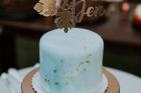 11 What a lovely blue watercolor wedding cake with a gold topper and gold leaf