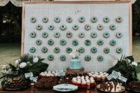 12 The wedding dessert table included a trendy wedding donut wall, with mint glazed donuts