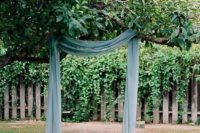 15 a creative backyard wedding arch made of a branch, blue fabric, candles all around is very eco-friendly as you are using a living tree