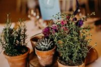 a lovely casual wedding centerpiece of pots, blooms and succulents is a lovely solution for many types of weddings