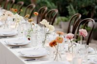 clear glasses with neutral and colorful blooms are classic centerpieces that match any wedding theme and style