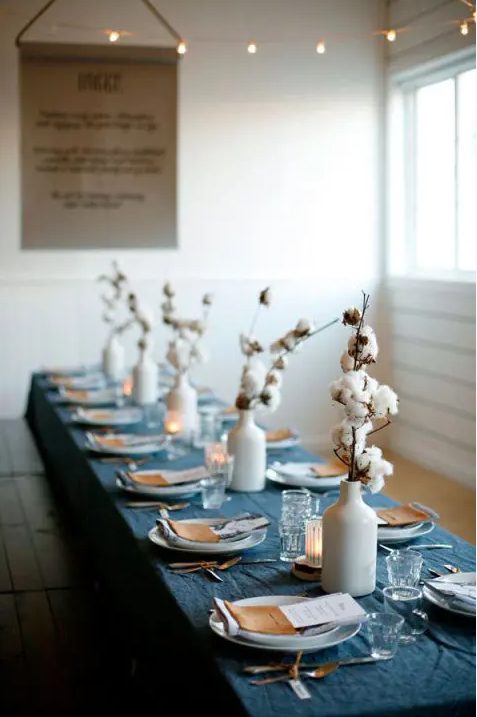 modern wedding centerpiece of white vases with cotton branches can be rocked at any boho wedding, in the fall or winter