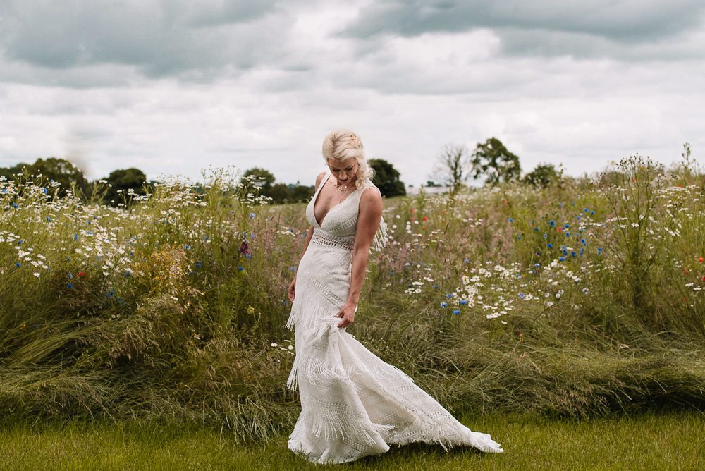 One bride was wearing a sheath boho wedding dress with a deep neckline and beading and fringe