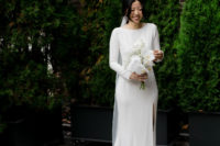 02 The bride was wearing a plain wedding dress with a high neckline, long sleeves and an open back plus a long veil