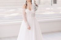 03 One bride was wearing a gorgeous off the shoulder A-line lace wedding dress with long sleeves and curls