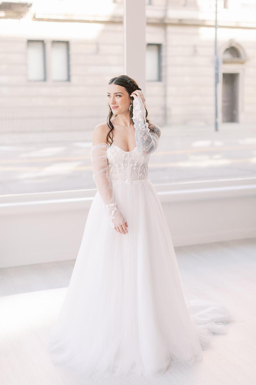 One bride was wearing a gorgeous off the shoulder A line lace wedding dress with long sleeves and curls