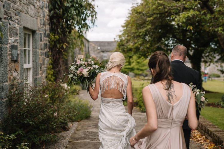 The back of the dress was open, with long fringe hanging down