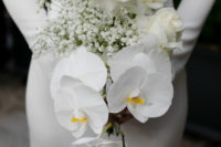 The wedding bouquet was done with white roses, orchids and baby’s breath
