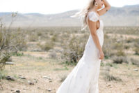 04 The bride was wearing an A-line wedding dress with a square cut, ruffle cap sleeves and tan boho lace