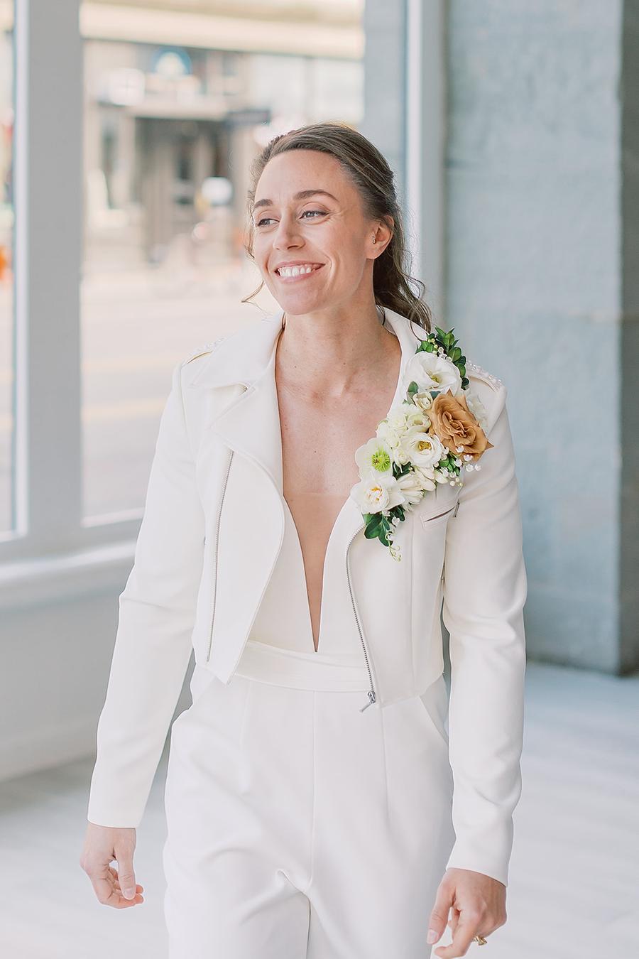The second bride was wearing a more rock look with a white jumpsuit, a white moto jacket and a lush floral boutonniere