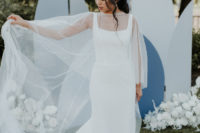05 The bride was wearing a minimalist sheath wedding dress with thick straps and a pearl capelet