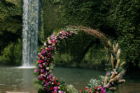 a cool round wedding arch by a waterfall