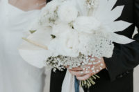 06 The wedding bouquet was all-white, with beautiful blooms and dried fronds