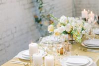 06 The wedding table setting was done with mustard linens, neutral and mustard blooms and pillar candles