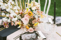 07 The wedding tablescape was done in blush and black, with black plates, chic menus, bold and lush blooms