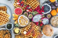 07 a simple wedding waffle grazing table with waffles, berries, tropical fruits, toppings and sauces
