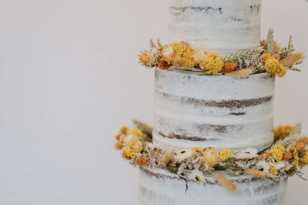 The wedding cake was a naked one decorated with dried blooms and greenery