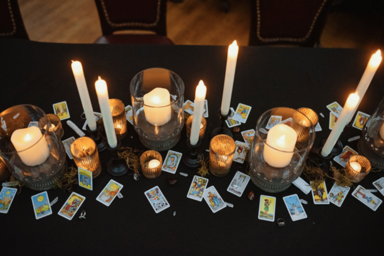 The wedding tablescape was done with lots of different candles, tarot cards and some moss