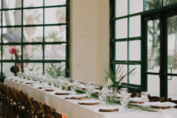 09 The wedding reception was decorated elegantly with tropical leaves and white blooms and white linens