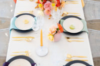 09 The wedding tablescape was done with bright florals, matte chargers, colorful napkins and citrus cards