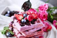 23 vegan berry waffles topped with blueberries, raspberries, strawberries and some blueberry sauce
