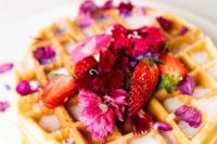25 waffles topped with bright blooms and strawberries plus creamy sauce are delicious
