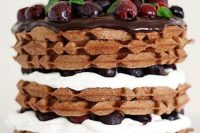 a black forest waffle cherry cake with mint and berries on top is a very decadent and tasty dessert
