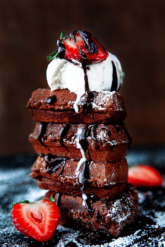 a brownie waffle stack with chocolate, ice cream and strawberries is amazing