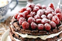 a chocolate waffle and mascarpone wedding cake topped with chocolate and raspeberries is jaw-dropping