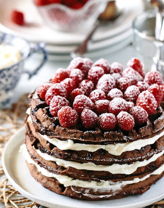 a chocolate waffle and mascarpone wedding cake topped with chocolate and raspeberries is jaw-dropping