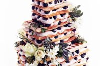 a cool and tasty square waffle wedding cake with cream, blueberries, flowers and greenery is a fantastic idea for a summer wedding