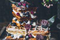 a gorgeous summer boho waffle wedding cake with blueberries and blackberries plus purple blooms and some caramel
