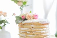 a pretty waffle wedding cake with pink blooms and leaves plus whipped cream inside for a spring wedding