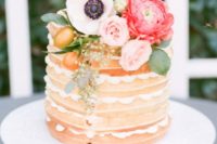 a small yet cute waffle wedding cake with pink and coral blooms, foliage and kumquats for a spring wedding