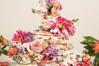a square waffle wedding cake with cream, fresh berries and colorful flowers is perfect for a colorful summer wedding