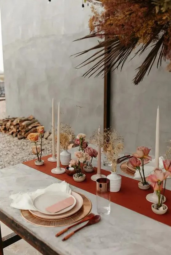 a stylish cluster wedding centerpiece with white and neutral vases, fresh and dried blooms and blush candles is pretty