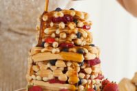 a waffle wedding cake with bleuberries, strawberries and caramel on top is delicious and tasty